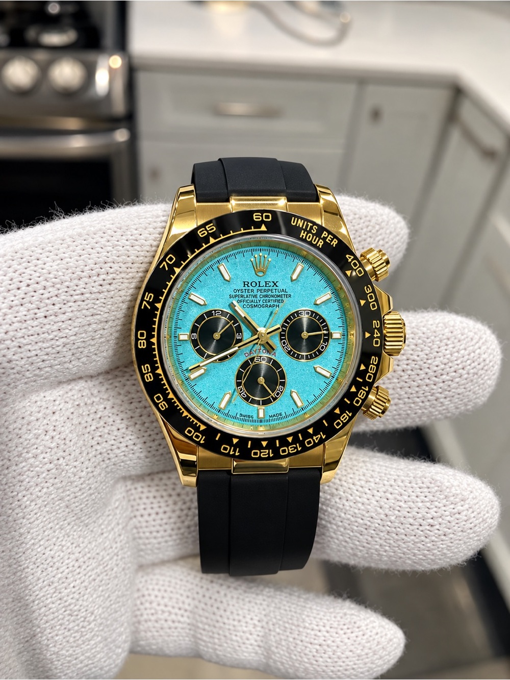 Rolex Gold Automatic Chronograph Watch with Turquoise Dial and Black Strap